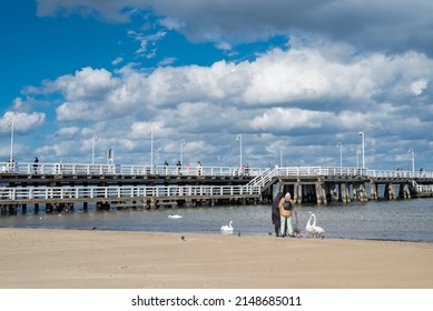 August 30, 2020, Gdask, Poland, View Of The Sopot Embankment On The Baltic Sea. People Feed The Seagull Birds