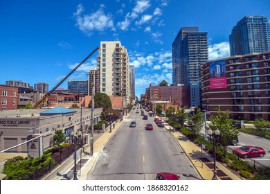 August 4th, 2020, Chicago, IL, Aerial Elevated View Looking East Down Division Street With Atrium Village Off To The Side Under A Blue Sky