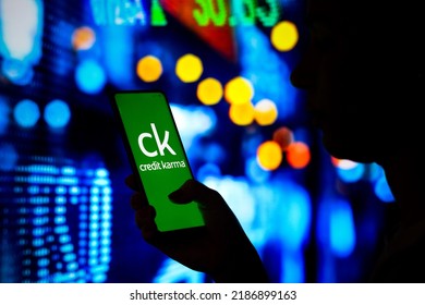 August 6, 2022, Brazil. In This Photo Illustration, A Woman's Silhouette Holds A Smartphone With The Credit Karma Logo Displayed On The Screen