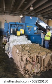 August 8, 2016- Salt lake city utah: man working machine to  bale paper and cardboard and prepared by a machine to be recycled