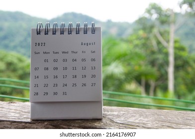 August calendar with blurred nature background. Copy space and new month concept
