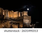 The August full moon rises over the Temple of Athena Nike and the Propylaia -  the gateway to the Acropolis of Athens -, casting its light over centuries of history beneath the Athenian sky. Greece