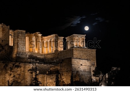 The August full moon rises over the Temple of Athena Nike and the Propylaia -  the gateway to the Acropolis of Athens -, casting its light over centuries of history beneath the Athenian sky. Greece