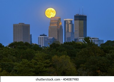 An August Supermoon Over Minneapolis, MN Skyline As Lights Of The City Turn On