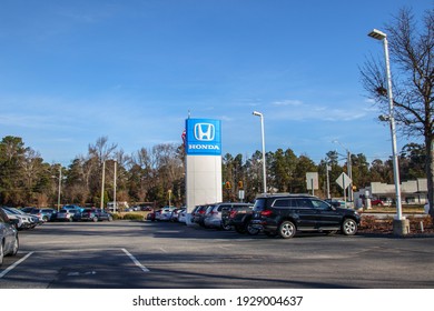 Augusta, Ga USA - 01 30 21: Honda Car Dealership Parking Lot Street Sign Distant