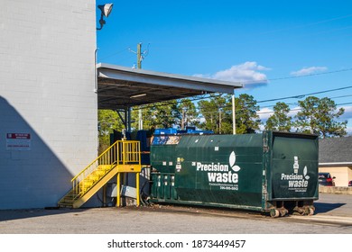Augusta, Ga USA - 11 04 20: Large trash compactor behind a Good Will store 