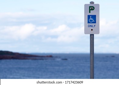 Augusta, Western Australia, 13/4/2020.
 Parking Sign For Access To The Beach For People With Disability, Sign On A Metal Pole With The Blue Ocean In The Background.
Augusta Community Area.