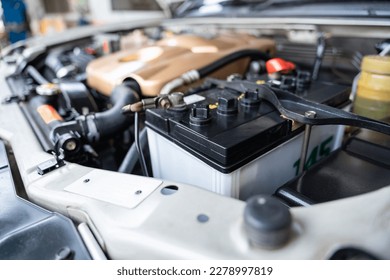 Auomobile repair, machine batteries car engine checking car battery cleaning for deliver customers in the car service. Batteries car. 