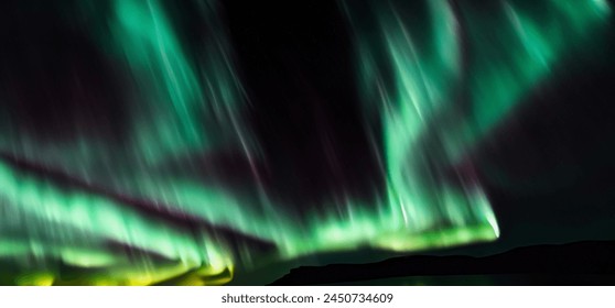 Aurora australis or Aurora borealis or Green northern lights sky above mountains. Night sky with polar lights. Night winter landscape with southern lights aurora against Real Natural black background. - Powered by Shutterstock