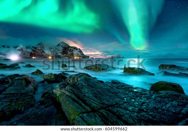 Aurora borealis\
above snowy islands of\
Lofoten