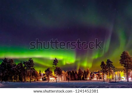 Aurora borealis (also known like northern or polar lights) beyond the Arctic Circle in winter Lapland.