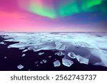 Aurora Borealis and iceberg pieces over black Diamond beach near Jokulsarlon lagoon, Iceland. Atlantic ocean waves and Northern lights on background. Polar lights