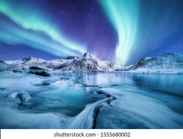 Aurora Borealis, Lofoten islands, Norway. Nothen light, mountains and frozen ocean. Winter landscape at the night time. Norway travel - image - Shutterstock ID 1555680002