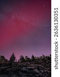 Aurora Borealis and Milky Way galaxy above northern Sierra Nevada mountain pass, Donner Pass, near Truckee and Lake Tahoe, California