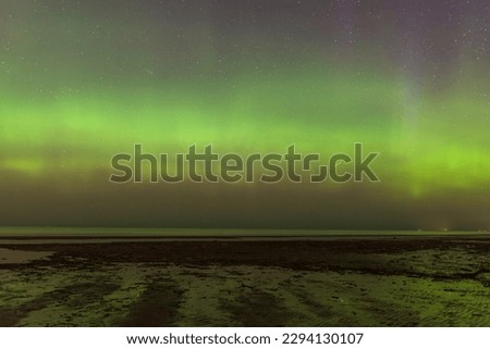 Aurora Borealis northen lights on the Baltic Sea beach in Latvia