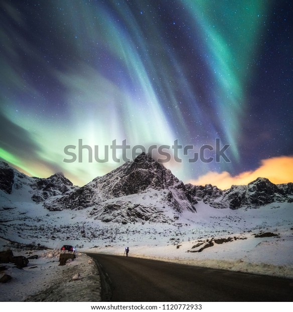 Aurora Borealis (Northern lights)\
explosion over snow mountain at Lofoten islands,\
Norway