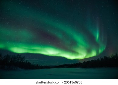 aurora borealis northern lights forest and mountains - Shutterstock ID 2061360953