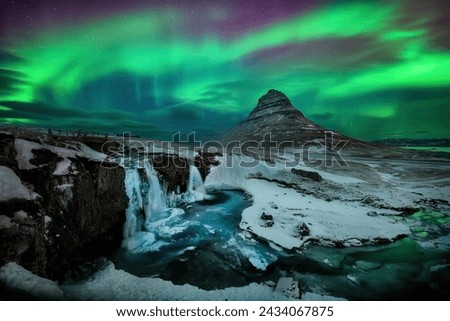Aurora borealis or northern lights over Kirkjufell Mountain in Iceland
