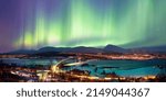 Aurora borealis or Northern lights in the sky over Tromso with Sandnessundet Bridge - Tromso, Norway