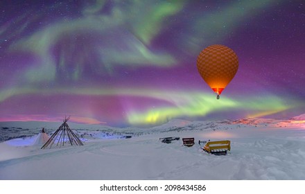 Aurora borealis or Northern lights    in the sky and triangle cloth tent with hot air balloon - Tromso, Norway