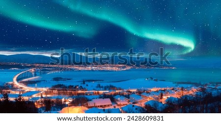 Aurora borealis or Northern lights in the sky over Tromso with Sandnessundet Bridge - Tromso, Norway