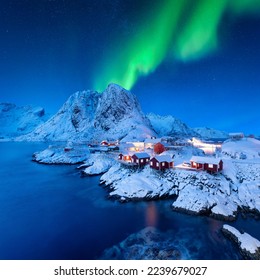 Aurora Borealis. Northern Lights. View on the house in the Hamnoy village, Lofoten Islands, Norway. Landscape in winter time. Mountains and water.  - Shutterstock ID 2239679027