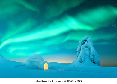 Aurora borealis. Northern lights in winter mountains. Wintry scene with glowing polar lights and snowy igloo. Landscape photography - Powered by Shutterstock