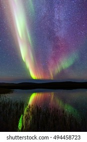 Aurora Borealis On Iceland With Lake Reflection