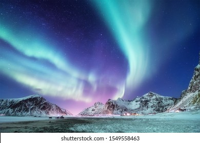 Aurora borealis on the Lofoten islands, Norway. Green northern lights above mountains. Night winter landscape with aurora. Natural background in the Norway - Shutterstock ID 1549558463