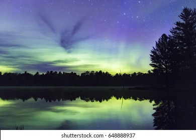 Aurora Borealis Over A Clear Lake In A Dark Sky Preserve.