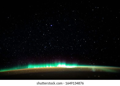 Aurora Borealis Aurora Borealis Over Planet Earth On A Background Of The Starry Sky. View From The Orbiting Space Station. Elements Of This Image Furnished By NASA.