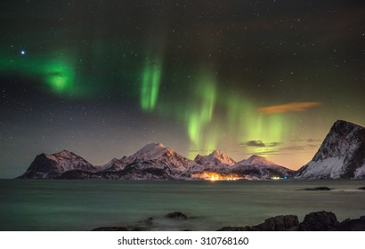 Aurora borealis (Polar lights) over the mountains in the North of Europe - Lofoten islands, Norway - Shutterstock ID 310768160