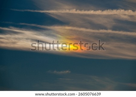 Aurora Borealis in a ray of sunshine in the sky before sunset