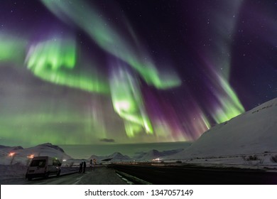 Aurora borealis with snow mountains.