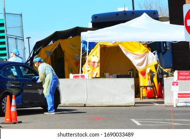 Aurora, CO, USA. March 31, 2020. Unidentified Hospital Workers Assisting A Patient At One Of The Many Drive Thru Coronavirus Testing Areas At A Local Hospital In Aurora, Colorado. 