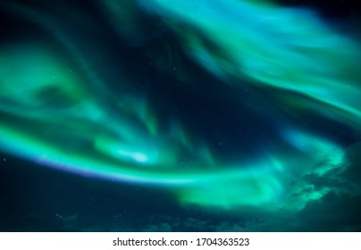 Aurora dancing in the sky. Northern lights over Lofoten Islands, Norway. Top travel destination. Night photography - Shutterstock ID 1704363523