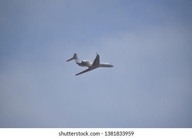 Aurora, Illinois - January 12, 2019: Small Jet Plane Flying Low Near Aurora’s Municipal Airport.