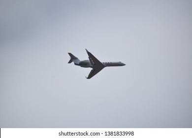 Aurora, Illinois - January 12, 2019: Small Jet Plane Flying Low Near Aurora’s Municipal Airport.