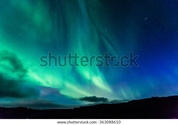 Aurora at night\
over the land as a\
background
