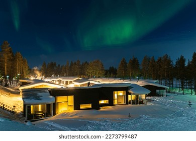 Aurora over a cottage in wintertime in Kuusamo, Finland.