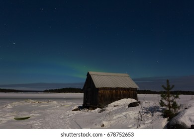 Aurora And A Small Wooden House Near The Sea