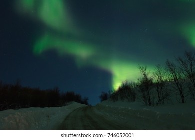 Aurora,Northern lights over the hills and road.Horizontal. - Shutterstock ID 746052001