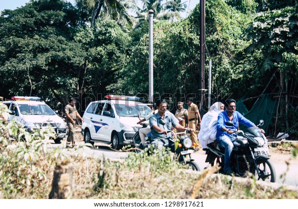 Auroville Tamil Nadu January 24, 2019 View of\
Indian police officers controlling cars at the road to Auroville in\
southern India in the\
afternoon