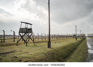 Auschwitz Birkenau II Nazi Concentration death Extermination Camp Oswiecim Poland17.10.19 Row of wooden guard watch towers tracks barb wire fence holocaust sorting train tracks ramp behind no people