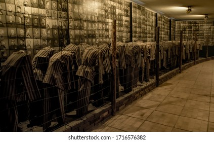 Auschwitz / Poland - November 29 2019: Striped prison uniforms and sewn serial number of Holocaust victims tortured during Nazi terror in Auschwitz concentration camp in Poland during World War II