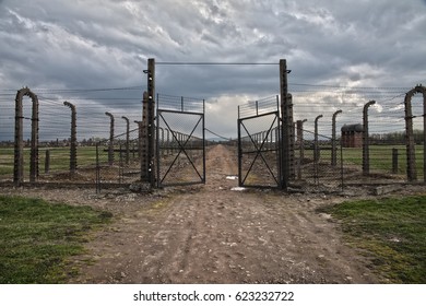 AUSCHWITZ-BIRKENAU, POLAND - APRIL 18, 2017 ; Museum Auschwitz - Birkenau. Holocaust Memorial Museum.  Barbed wire and fance around a concentration camp. Side entrance of the concentration camp.