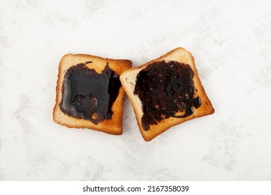 Aussie savory toasts for breakfast. Vegemite is a very popular yeast based spread in Australia. Grey textured background, copy space.