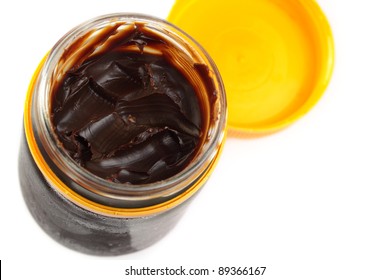 Aussie vegemite, complete with toast crumbs. Isolated on white.