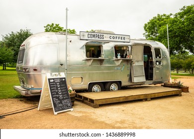 AUSTIN - CIRCA MAY 2019: People drink coffee at a local food truck called Compass Coffee in east Austin, Texas. The food truck serves a wide variety of coffee drinks.