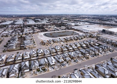 Austin Suburb Homes With Snow Covered Rooftops After Winter Storm Drops Ice And Snow Over Central Texas. Aerial Drone View Above Neighborhood Frozen After Winter Storm Landon